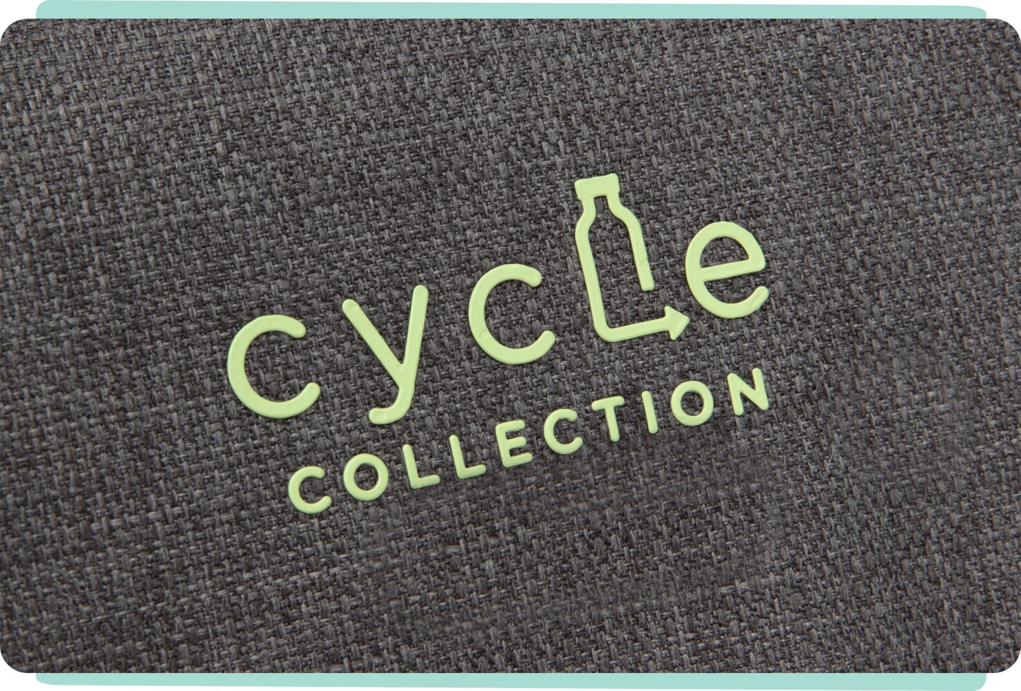  Closeup on a green Cycle Collection logo on dark gray fabric.