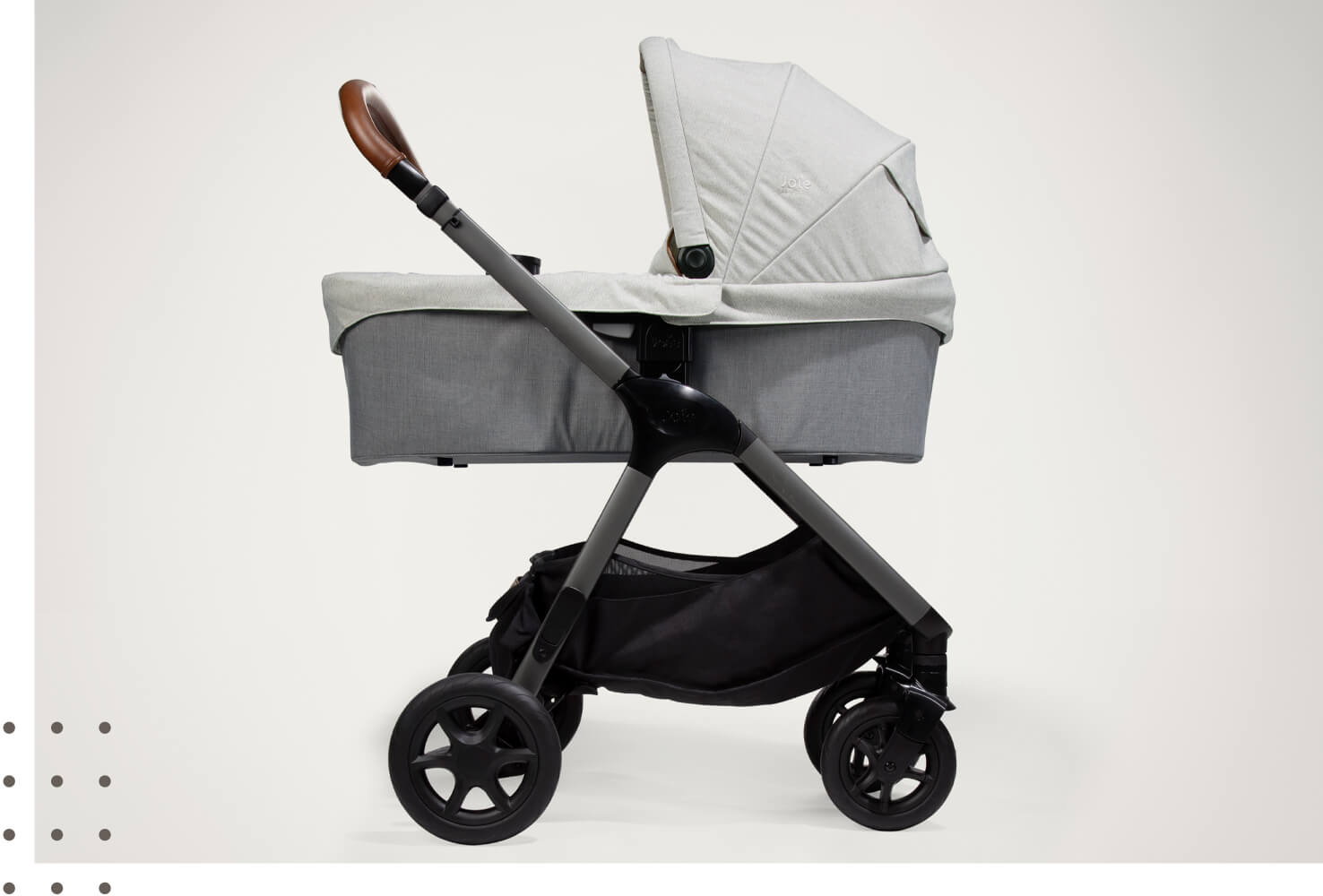 Joie Signature ramble xl carry cot on a pushchair in dark and light gray from a side view with hood raised. 