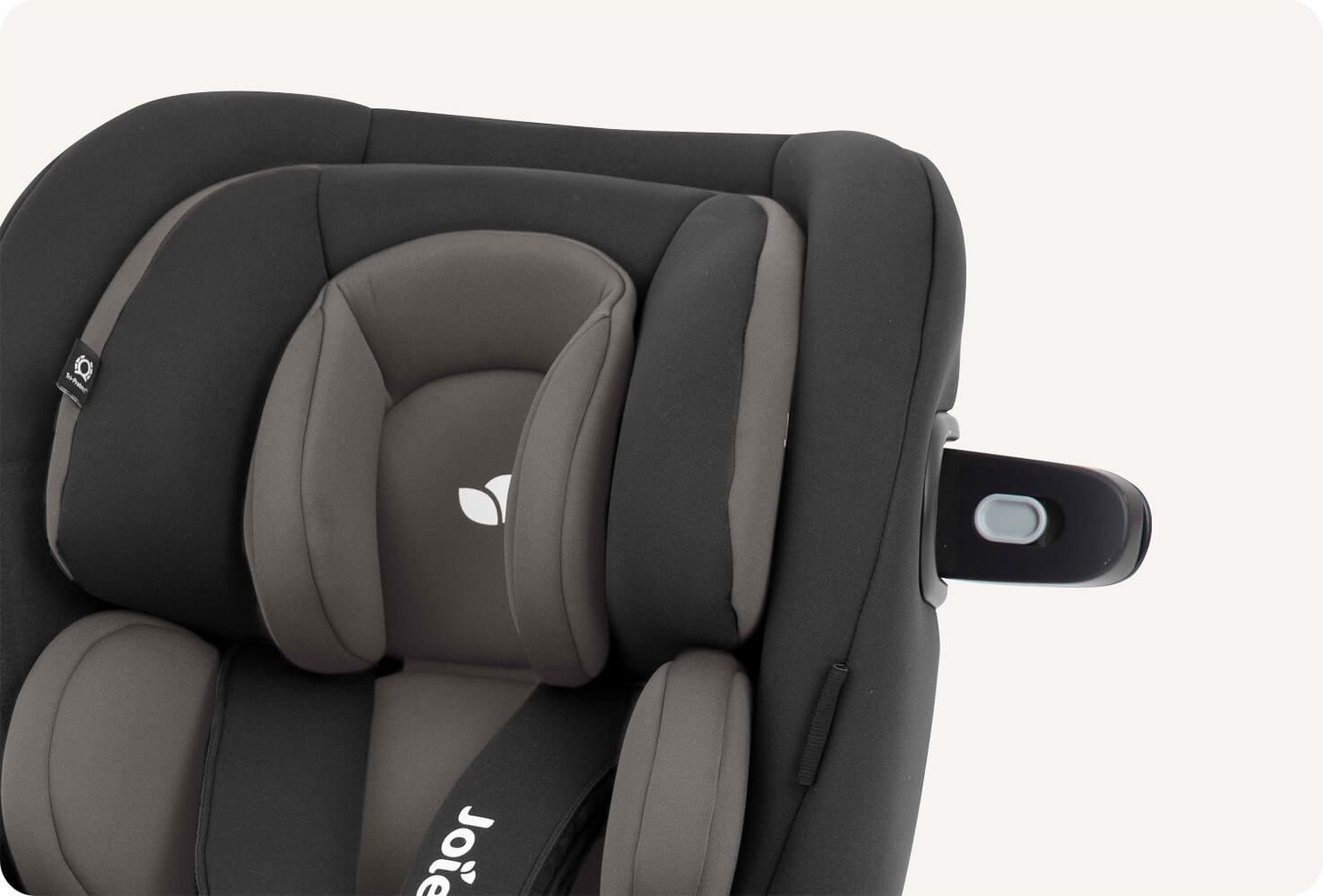  Closeup of the headrest on a black Joie i-Venture car seat.
