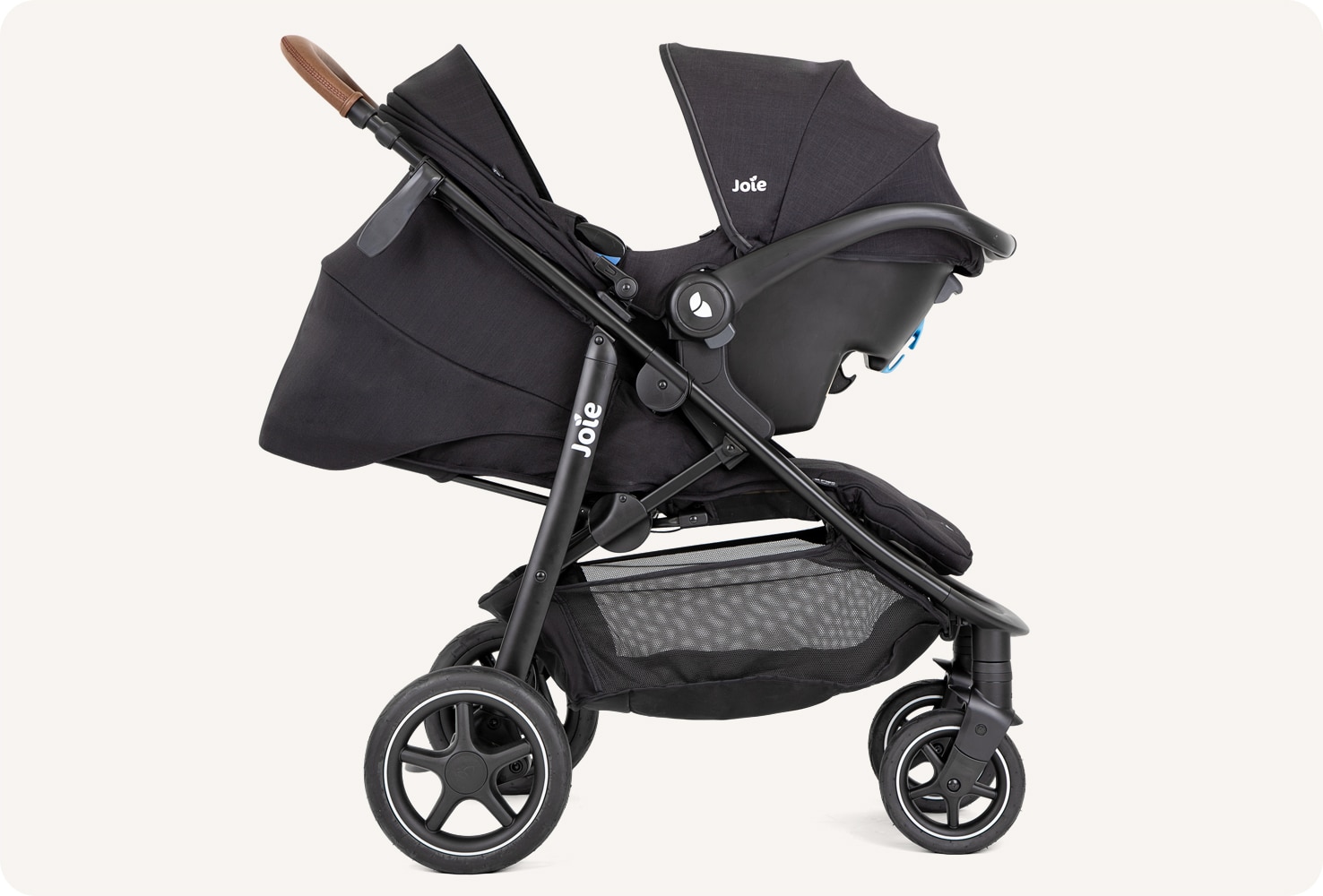 Joie mytrax pro in dark gray with an infant carrier attached.