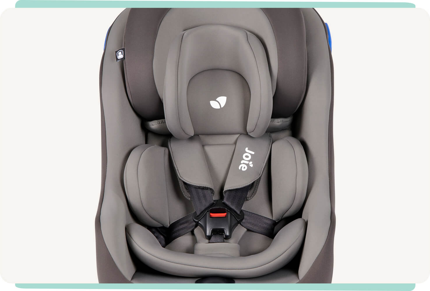 Joie Steadi car seat with harness clipped in with a tan two tone colour, and facing forward with infant insert. 