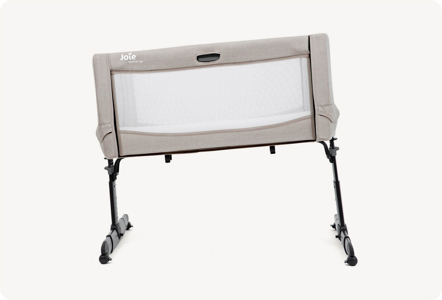 Front view of light grey Joie Roomie Go bedside crib, displaying tilt feature.