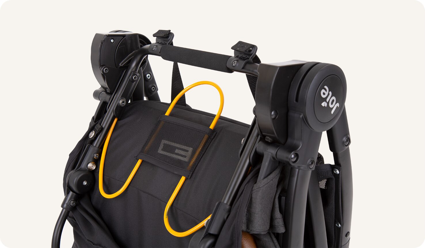 A closeup on a folded Pact Flex stroller.