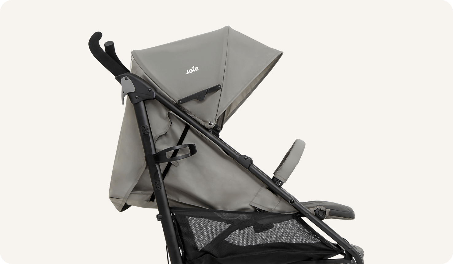  A closeup of the Joie Brisk LX stroller in two tone gray, in profile facing to the right with the seat fully reclined.