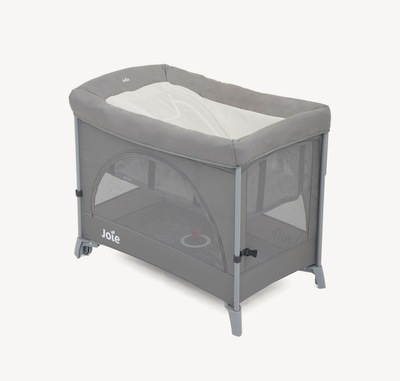  A gray and cream colored Joie Daydreamer napping seat attached to a Kubbie travel cot sitting at an angle facing right