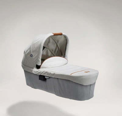 Joie Signature ramble xl carry cot in light gray at a right angle with hood raised.
