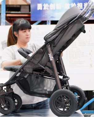 Manufacturing associate assembling a Joie stroller.